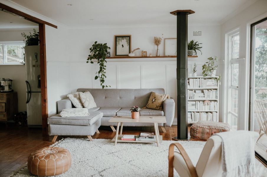 a gray couch and other furniture in the Scandinavian design styled living room