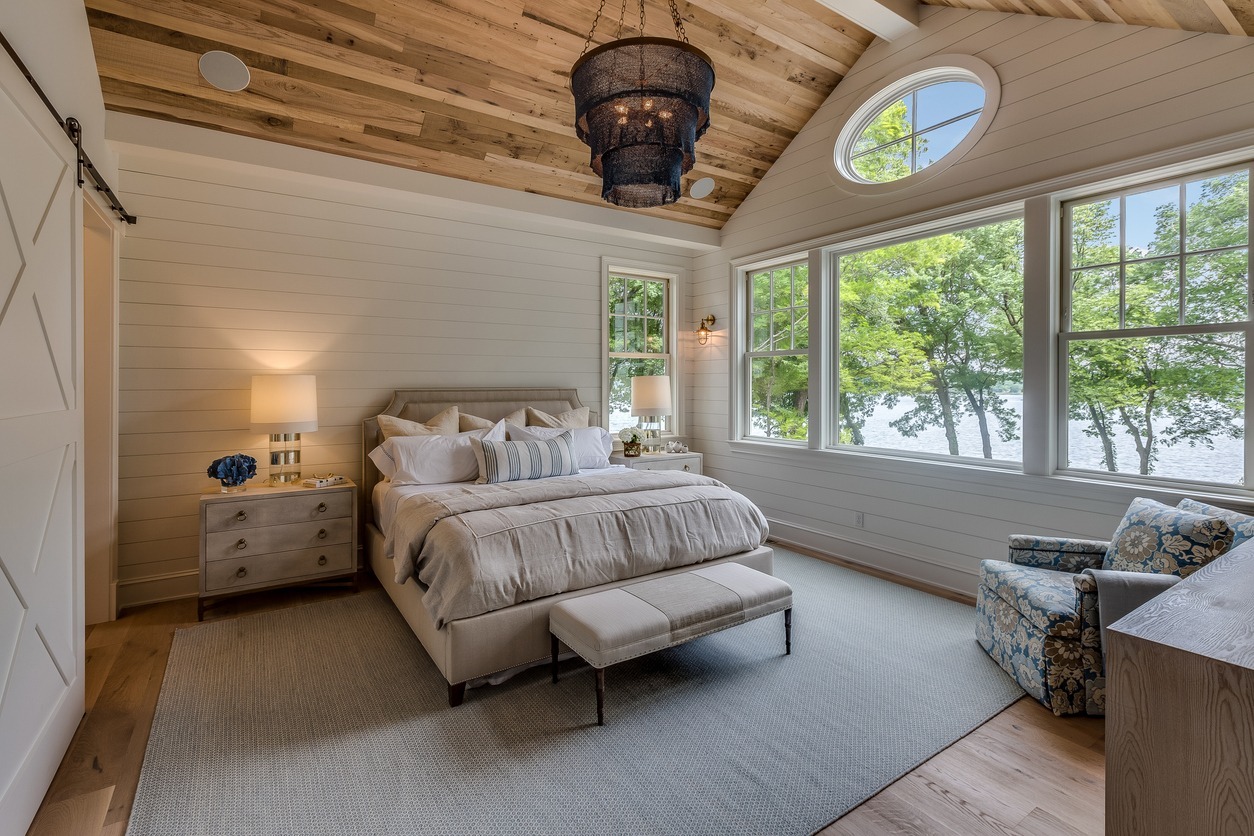a modern farmhouse bedroom interior, with cream colored beddings