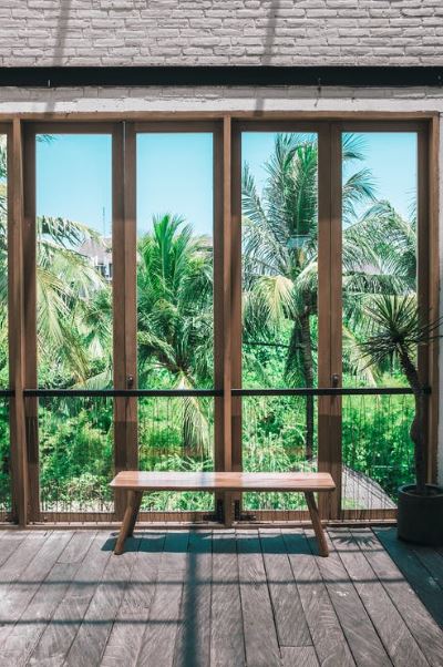an interior with a view of a tropical forest from the windows