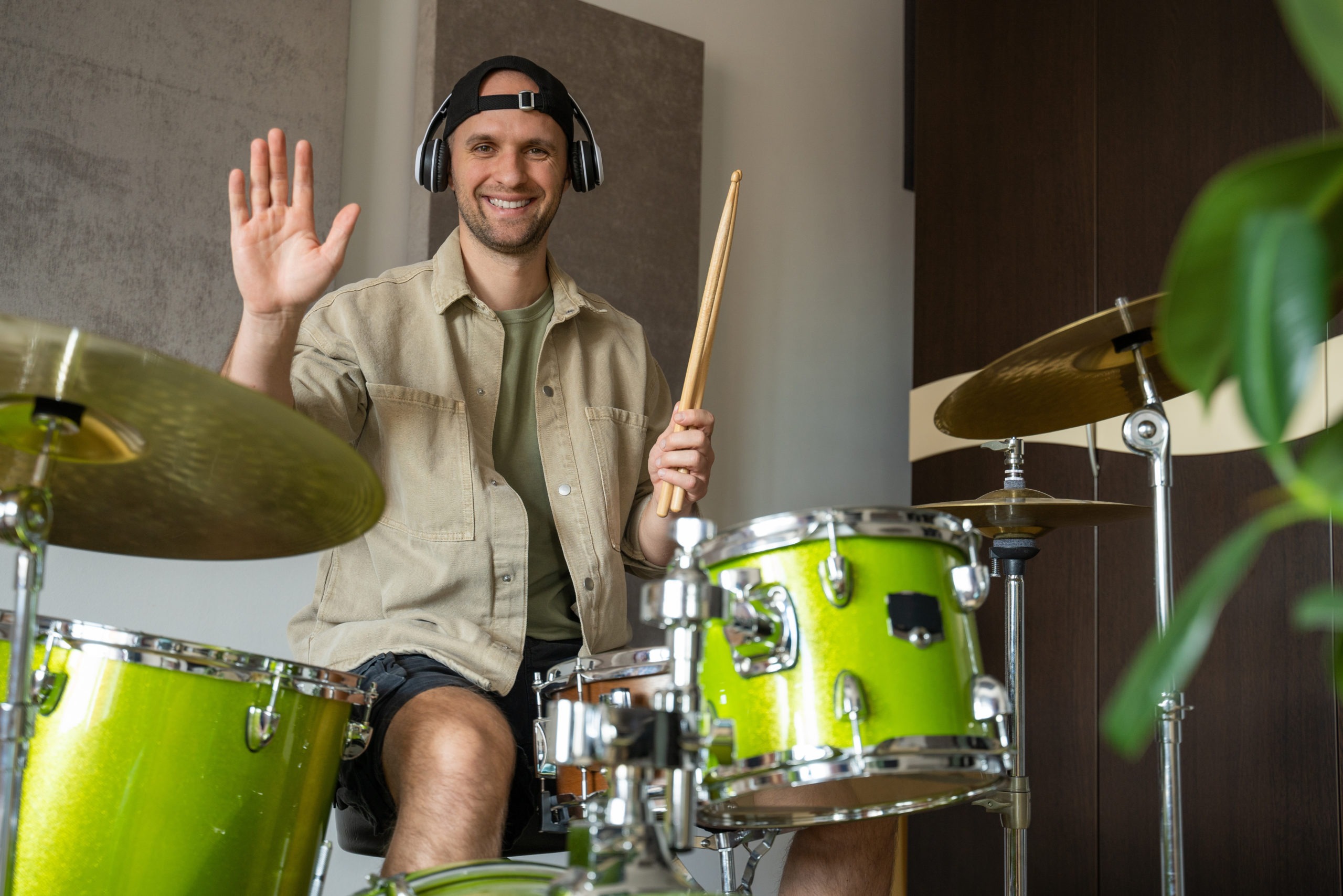 Man records drum lesson demonstrating playing drums