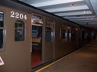  a portion of an old brown train with number 2204 printed in whit