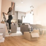 Girl standing on ladder and celebrating at home