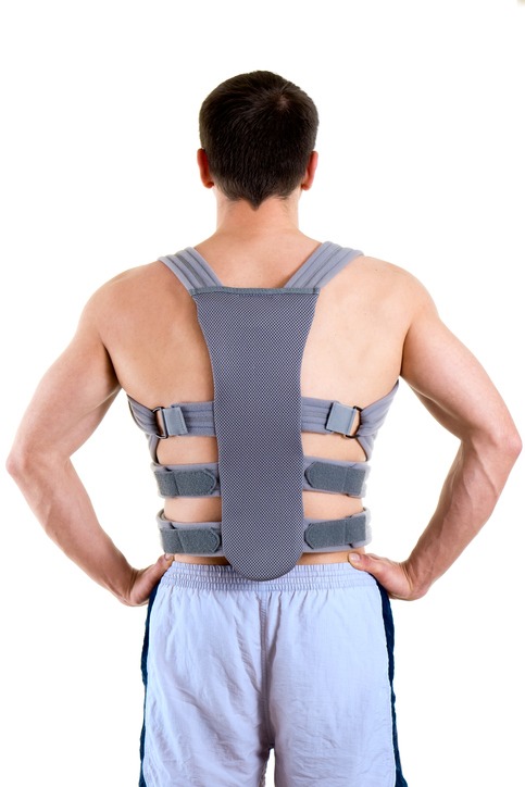 Athletic Man Wearing Supportive Back Brace.