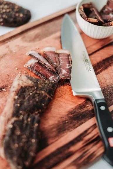 Biltong on a chopping board with knife