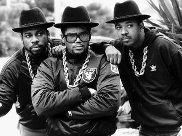 Run-DMC in a promotional shot. From left to right: Jason Mizell, Darryl McDaniels, and Joseph Simmons.