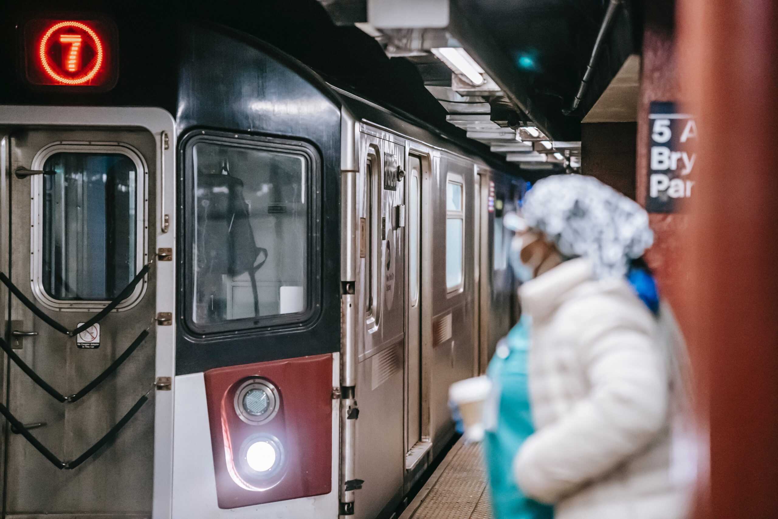 A nurse waiting for an incoming subway train