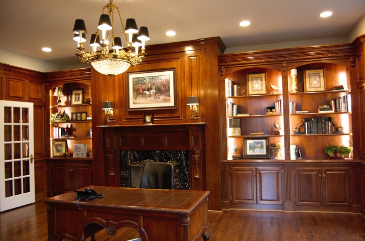 A home office with wood paneling in the traditional style