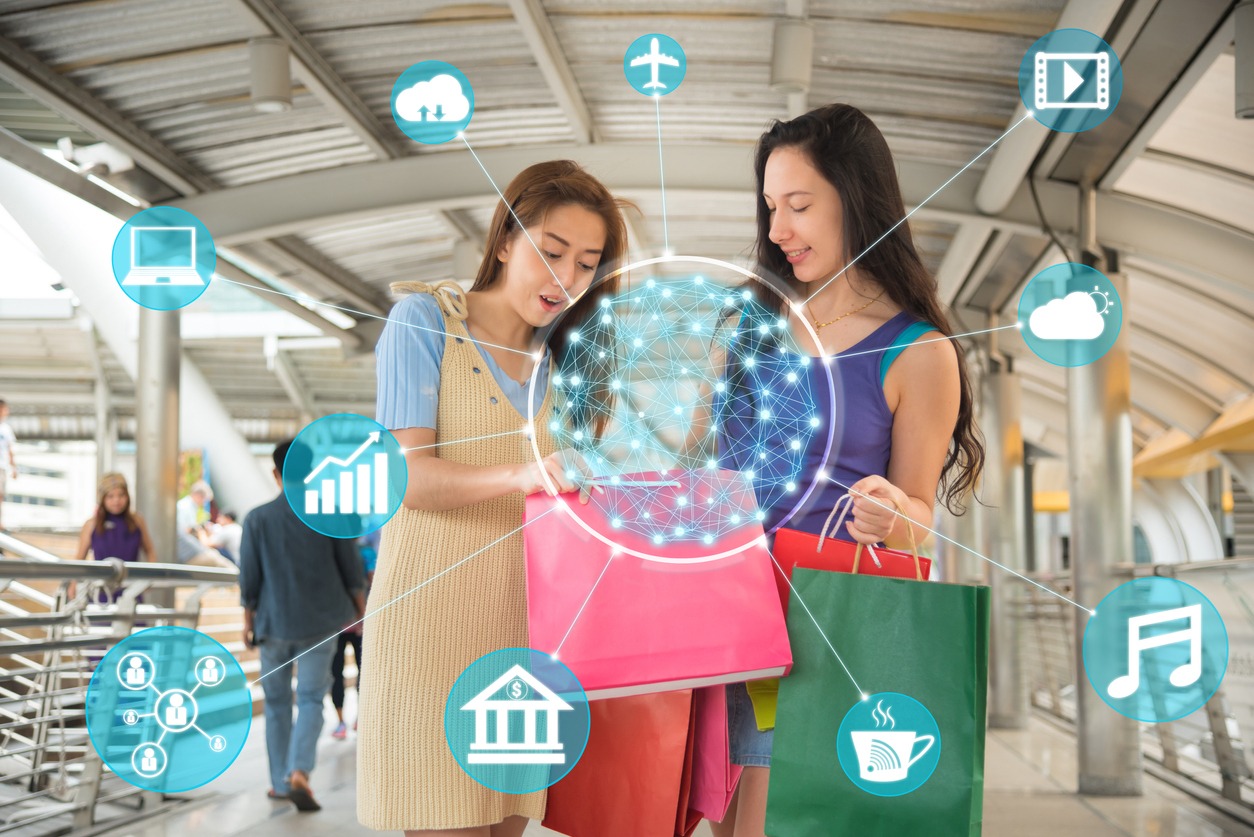 Digital Composite Image Of Female Friends With Shopping Bags Standing and various icons