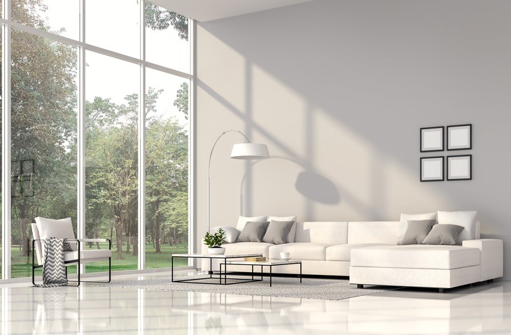 Living room with white floors and gray walls, furnished with white fabric furniture