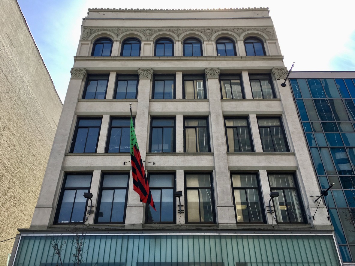 Studio Museum in Harlem building on 125th Street with artist David Hammons' African-American flag in the Pan-African colors red, black and green hanging in front