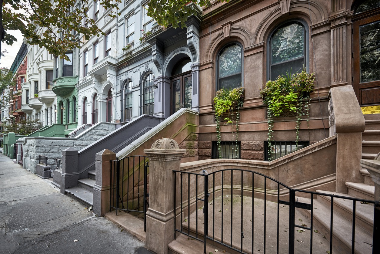 a row of colorful brownstone buidlings