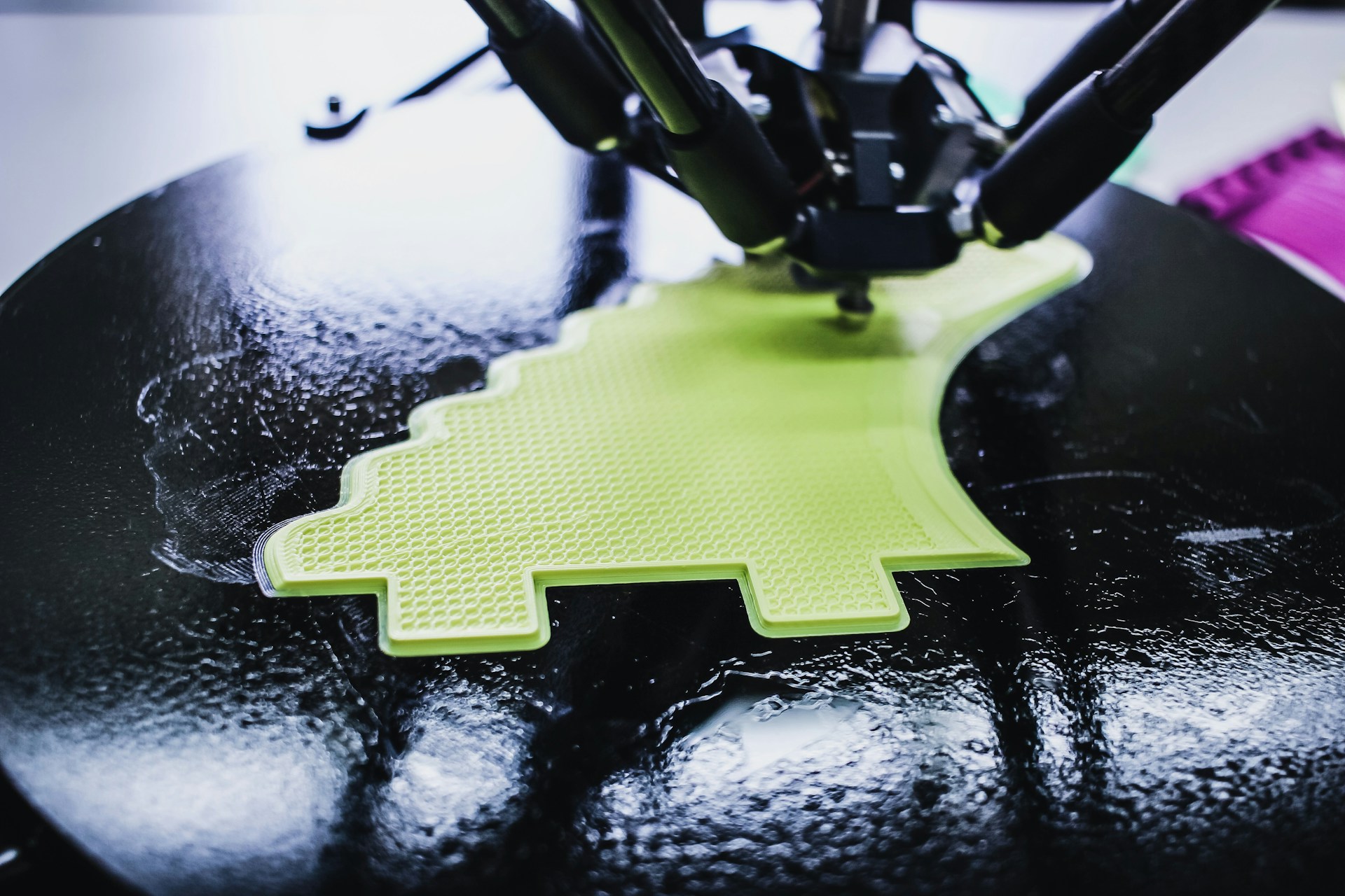 black 3D printing machine printing on black and green