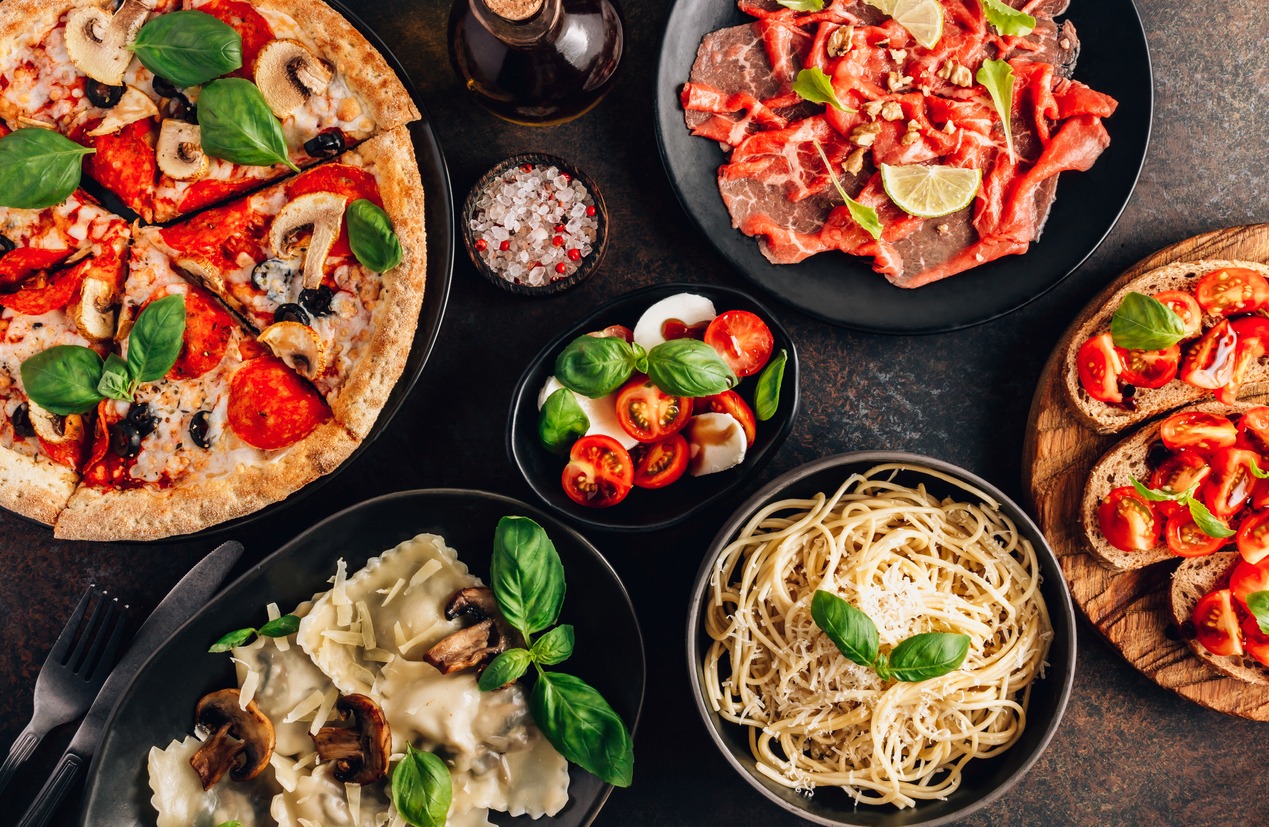 full table of Italian meals on plates