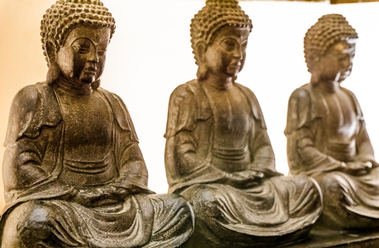 three stone Buddha statues