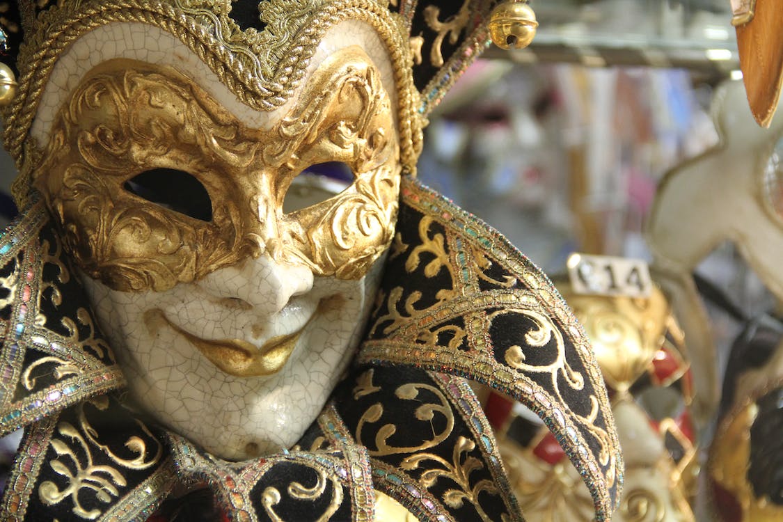 white and gold themed traditional carnival mask