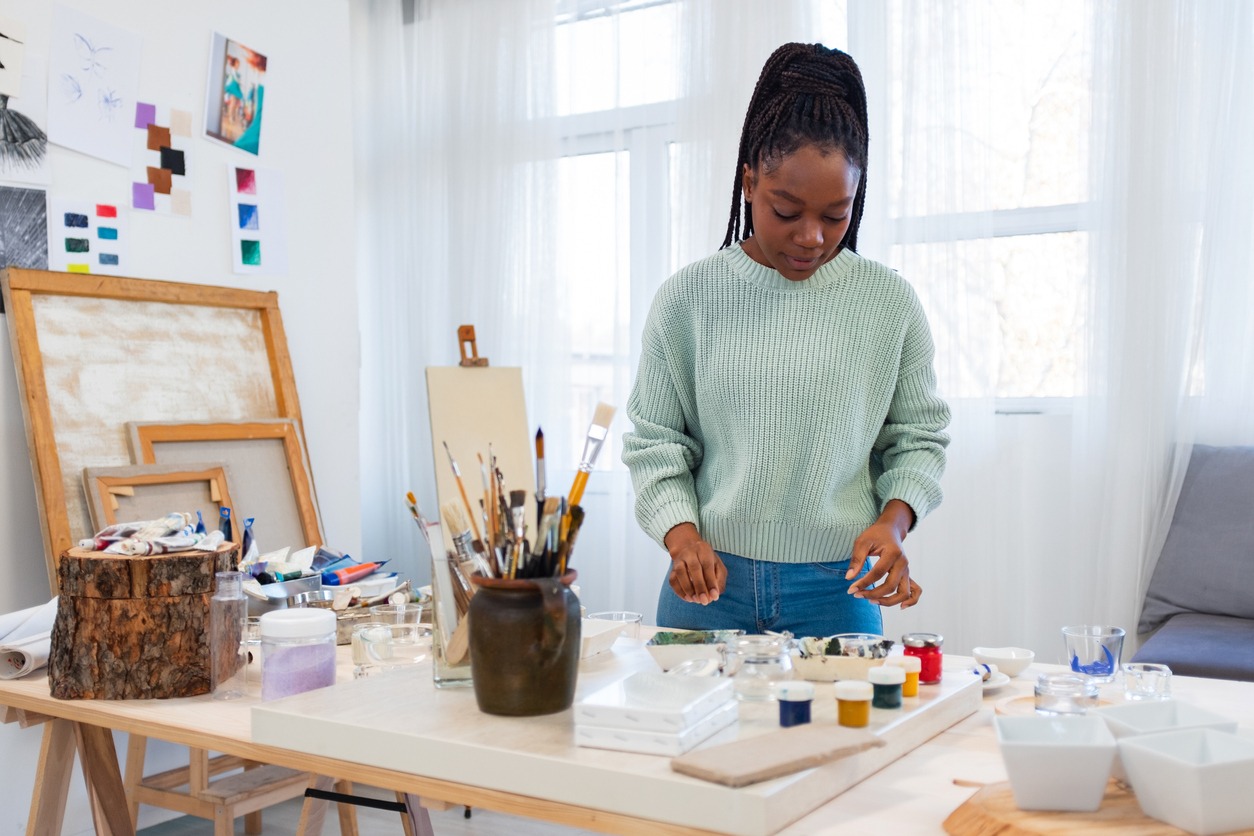 young female artist is in her painting studio