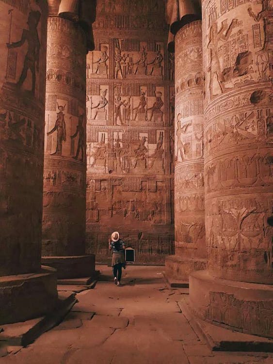 A Tourist Looking at Pillars inside the Dendera Temple