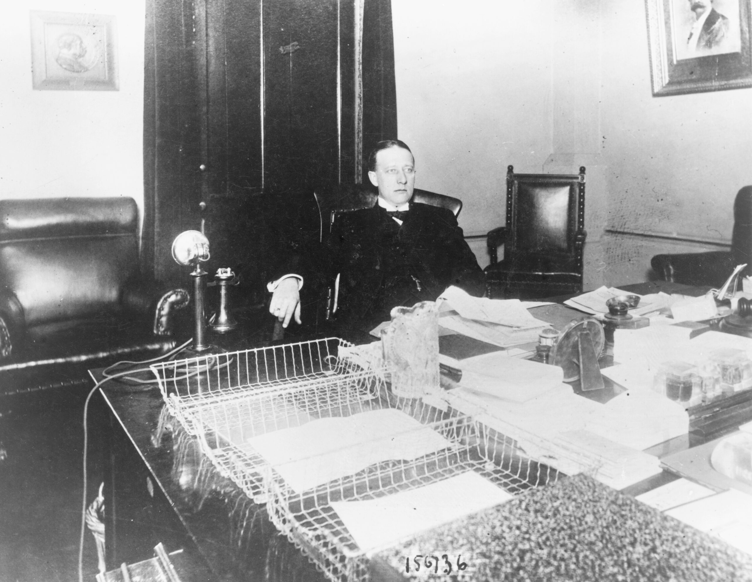 Al Smith seated at his desk as a New York State Senator in 1913