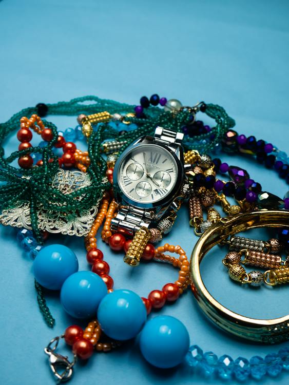 Silver Wristwatch and Accessories on a Blue Surface