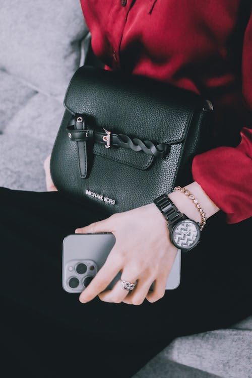Woman with Black Bag Wristwatch and Smartphone