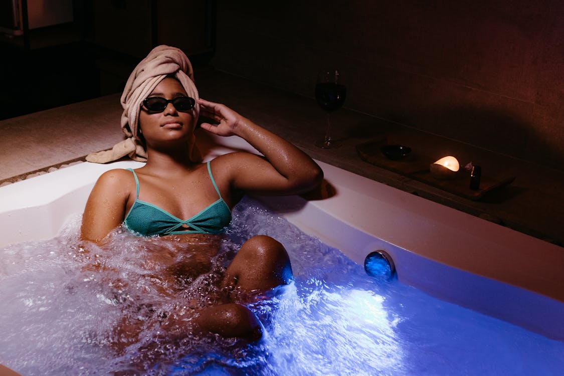 Young Woman in Green Bikini Relaxing in a Hot Tub