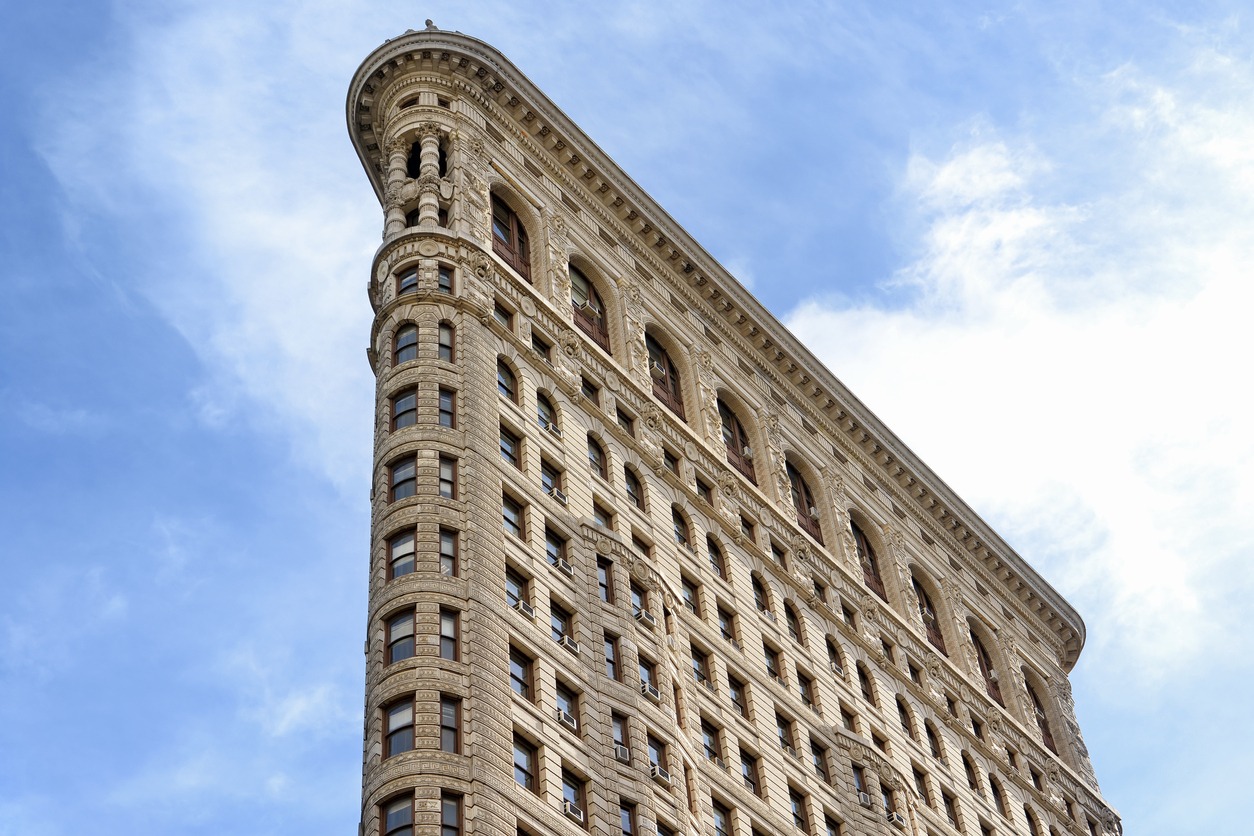 the famous Flatiron Building at the intersection of Fifth Avenue and Broadway in Manhattan, New York City, USA