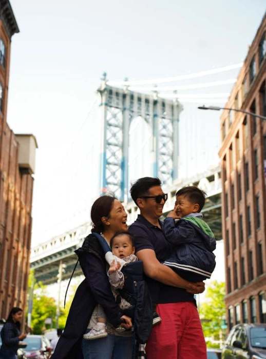 Smiling Mother and Father with Children near Brooklyn Bridge