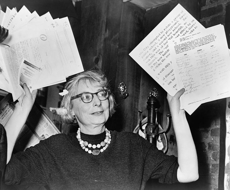 Mrs. Jane Jacobs, chairman of the Comm. to save the West Village holds up documentary evidence at press conference at Lions Head Restaurant at Hudson & Charles Sts.