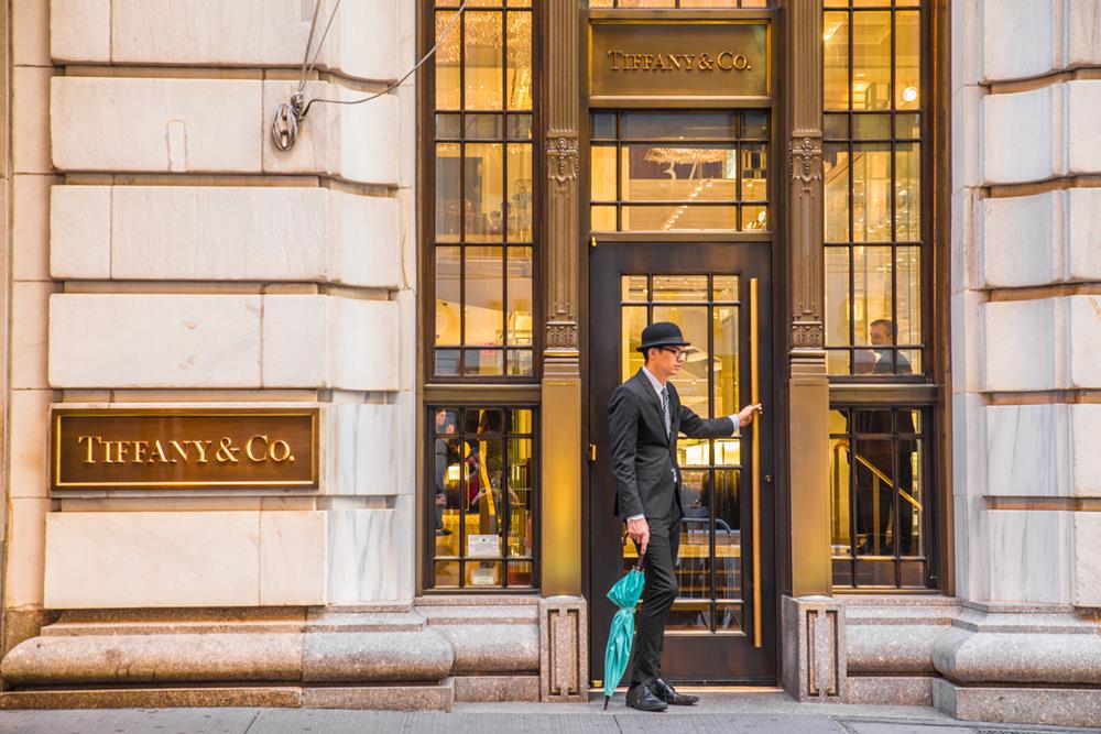 Exterior view of Tiffany & Co. on Wall Street in Manhattan with a doorman