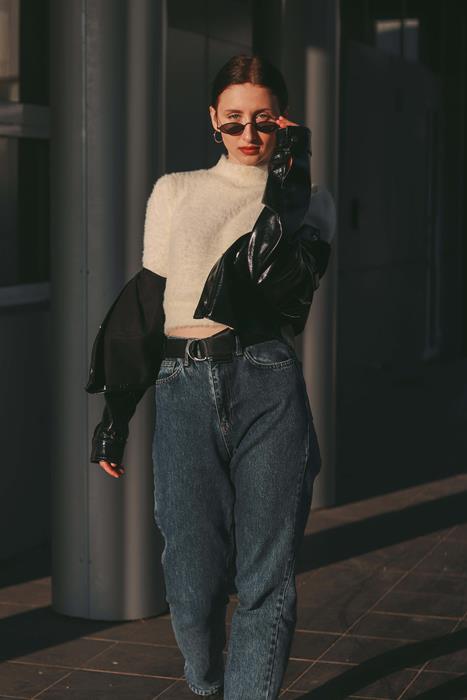 Female Model Wearing Jeans and Black Jacket Posing in Street