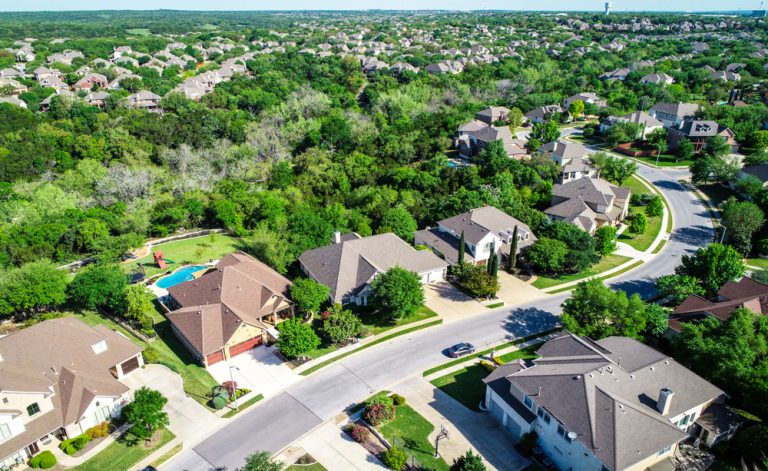 Aerial drone view above suburb homes in a neigborhood in Austin